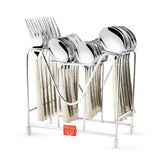 Stainless steel cutlery set with patterned handles neatly arranged in a silver metal stand.